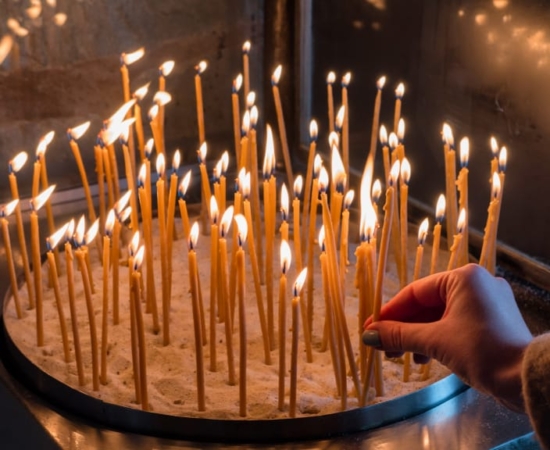 Lit candles in a Greek Orthodox church Lit candles in a Greek Orthodox church