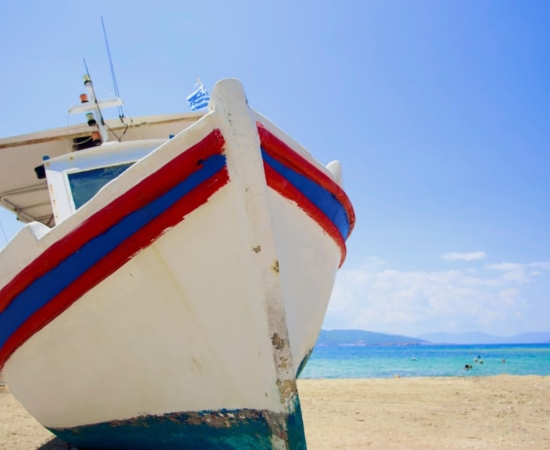 A fishing boat in a Paros' sandy beach.