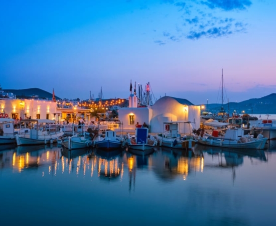Naoussa fishing village port in Paros Island, in the Cyclades, at night. Naoussa fishing village port in Paros Island, in the Cyclades, at night.