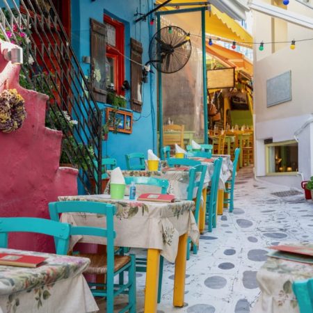 Colored chairs in an alley in Tinos.