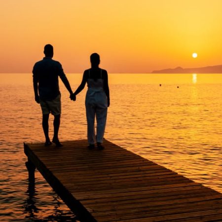 Sunset, couple holding hands